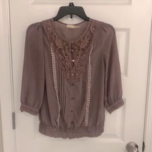 Lilac blouse with lacy adornments and buttons